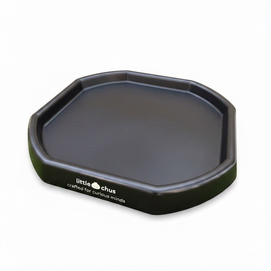 A black plastic tray with raised edges, featuring the white printed brand name 'little chus' on the front left side, set against a plain white background.