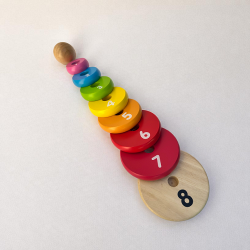 A wooden stacking number toy with colorful circular rings numbered 1 through 8, arranged in a diagonal stack on a light off-white background.